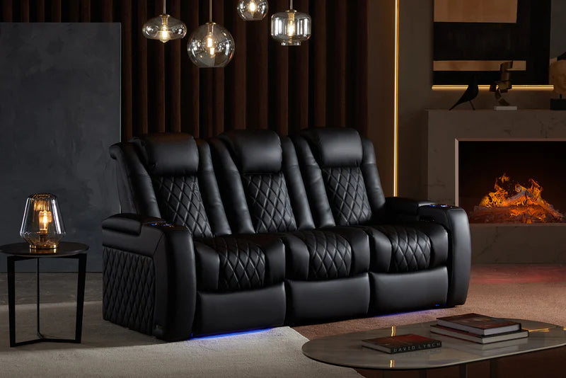 The Tuscany Home Theater Seating in the set of 3 configuration and midnight black color in a cozy room with a fireplace and modern look