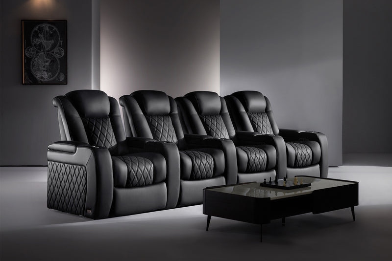 The Valencia Tuscany Ultimate Edition Home Theater Seating in a row of 4 configuration and onyx color in a modern minimalistic room painted in grey with a painting on the wall and a table on the floor